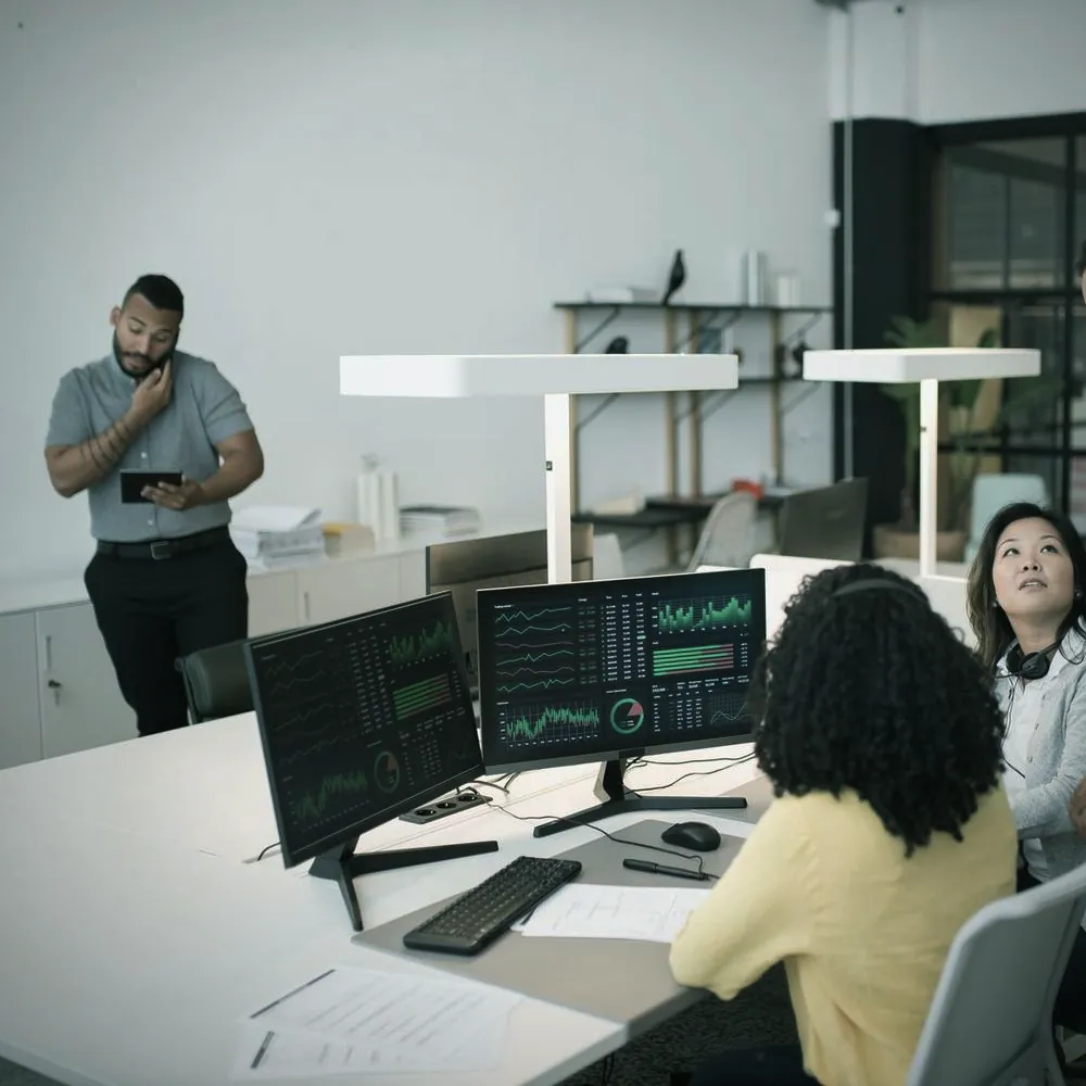 An operations team working together at their monitors