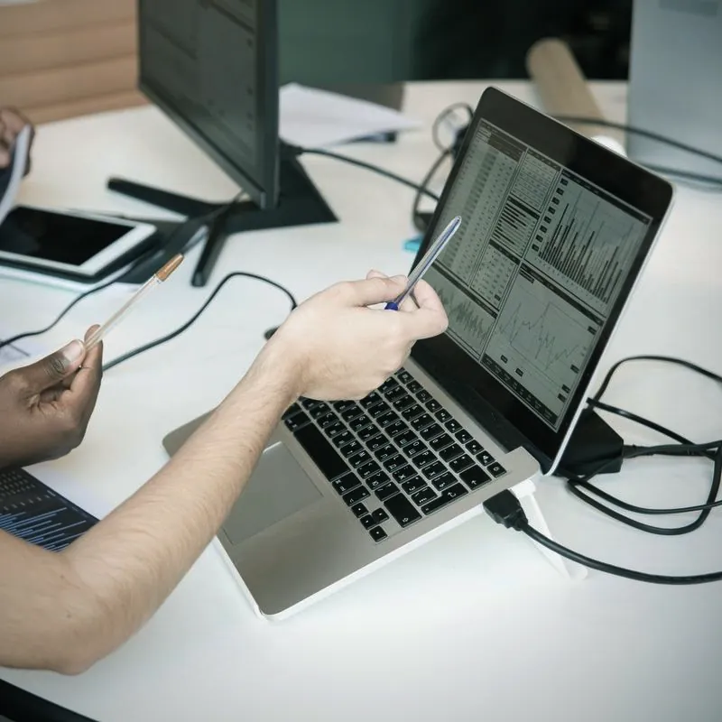 Reviewing revenue charts on a laptop